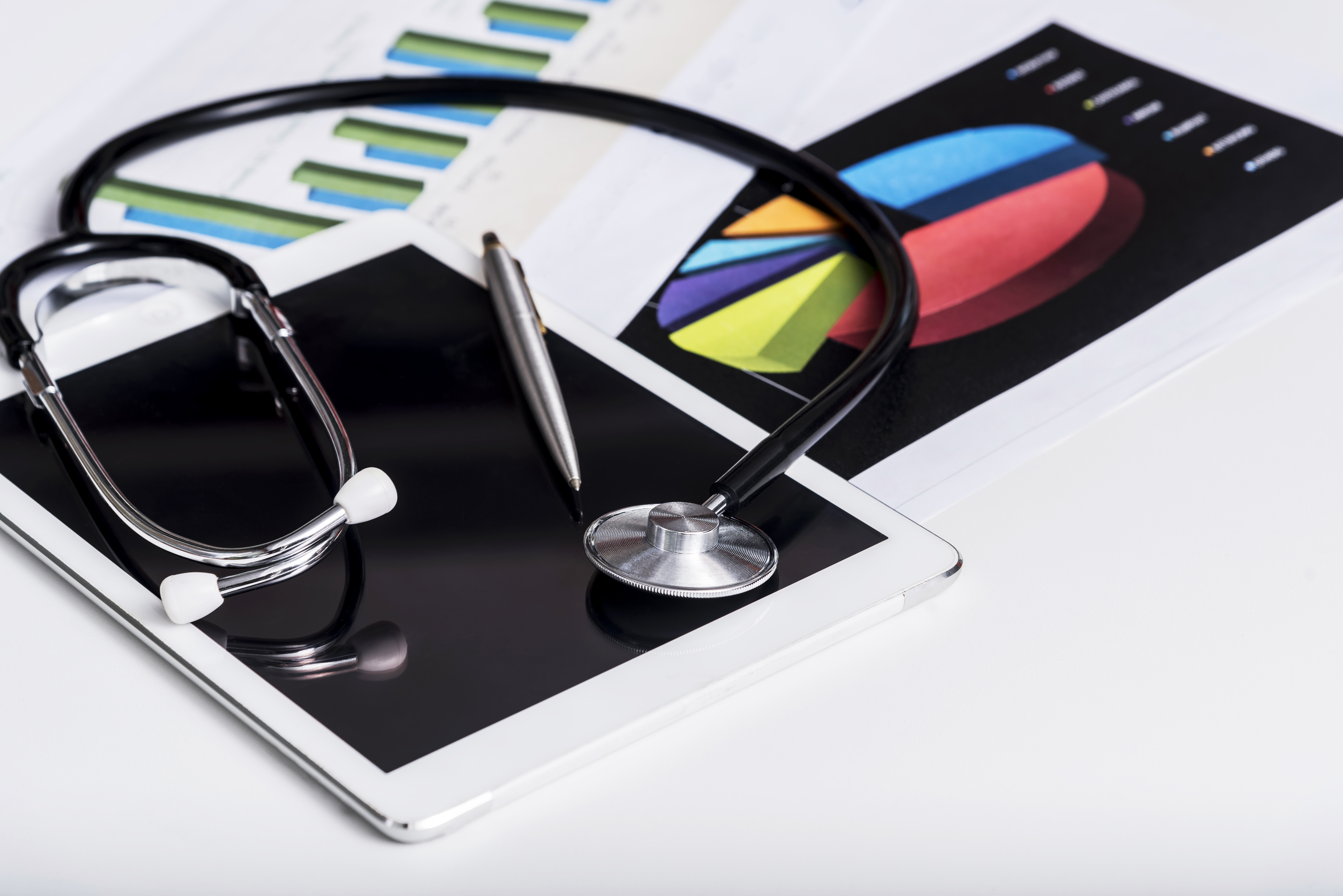 healthcare-business-concept-stethoscope-tablet-with-report-chart-paper